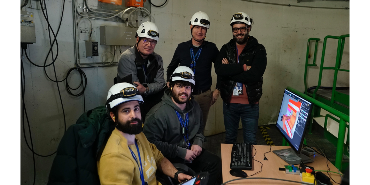 team smiling in front of PCs 