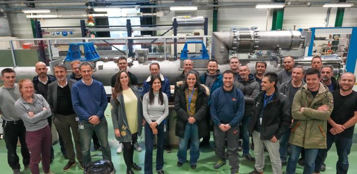group of people smiling in front of equipment