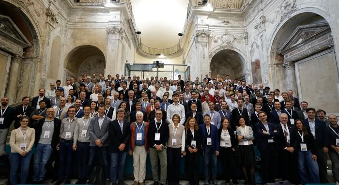 big group photo of over 100 people in an old church